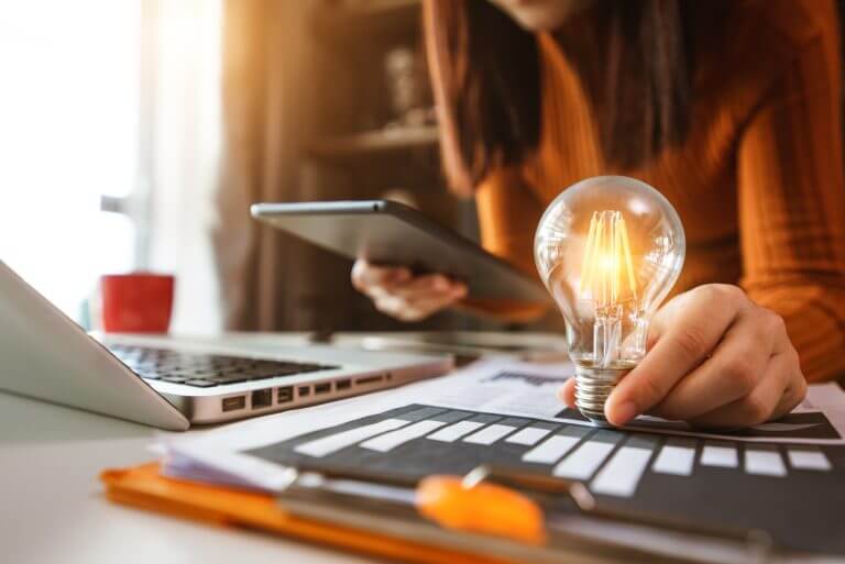 business hand showing creative business strategy with light bulb